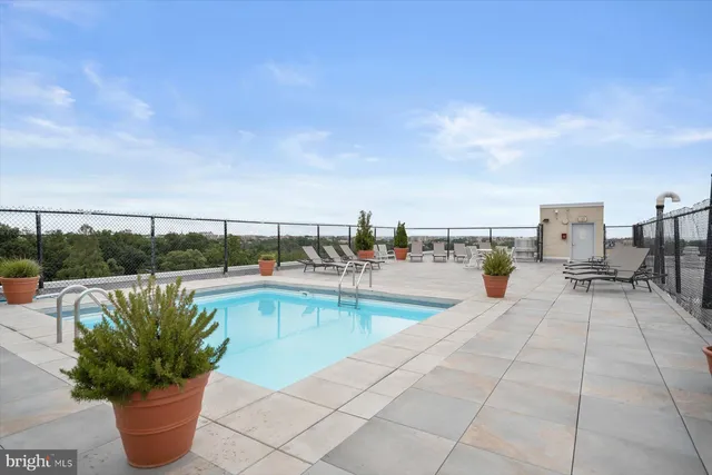 a view of a swimming pool with outdoor seating