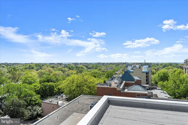 a view of a balcony with couches and city view