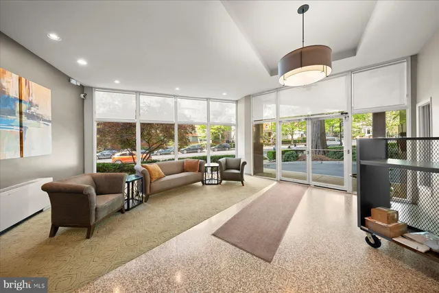 a living room with furniture and a large window with outer view