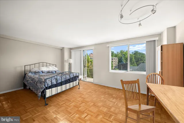 a living room with a bed furniture and a large window