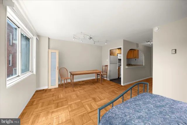 a bedroom with furniture and a window