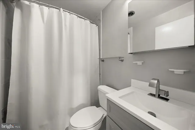 a white toilet sitting next to a bathroom sink
