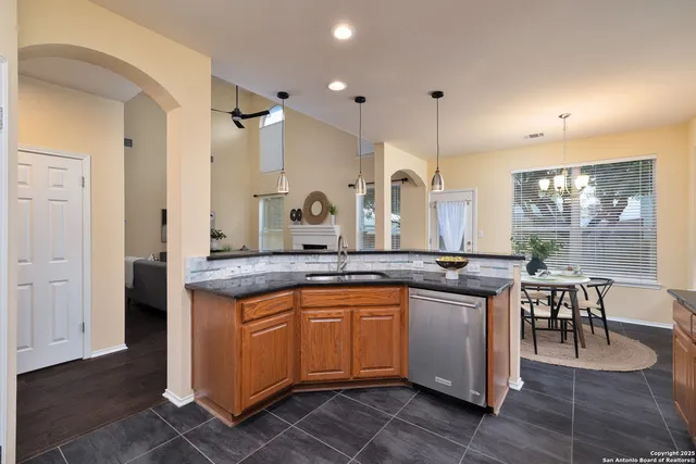 a kitchen with center island table and chairs