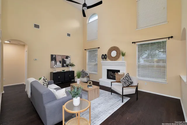 a living room with furniture a fireplace and a table