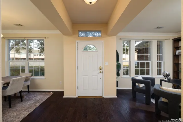 a view of a livingroom with furniture wooden floor and windows
