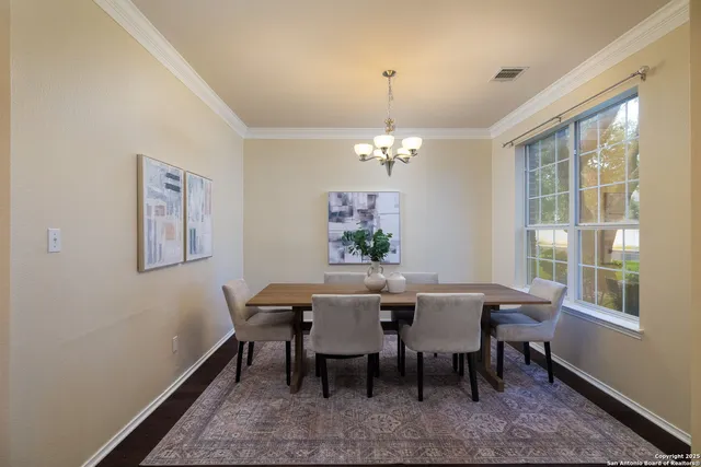 a view of a dining room with furniture and chandelier