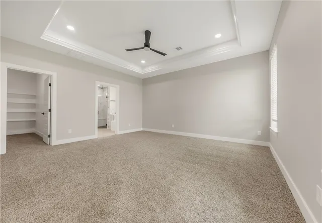 an empty room with closet and windows