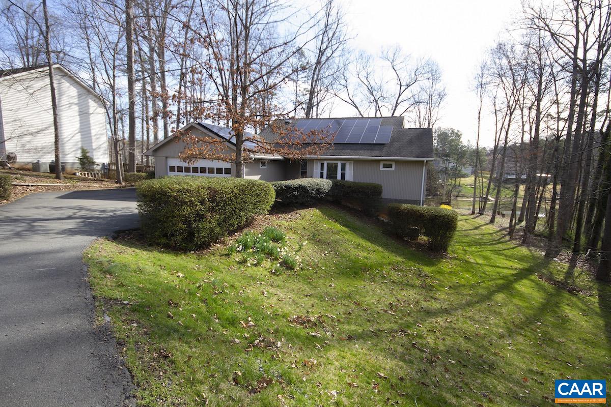 a view of a house with backyard sitting area and garden