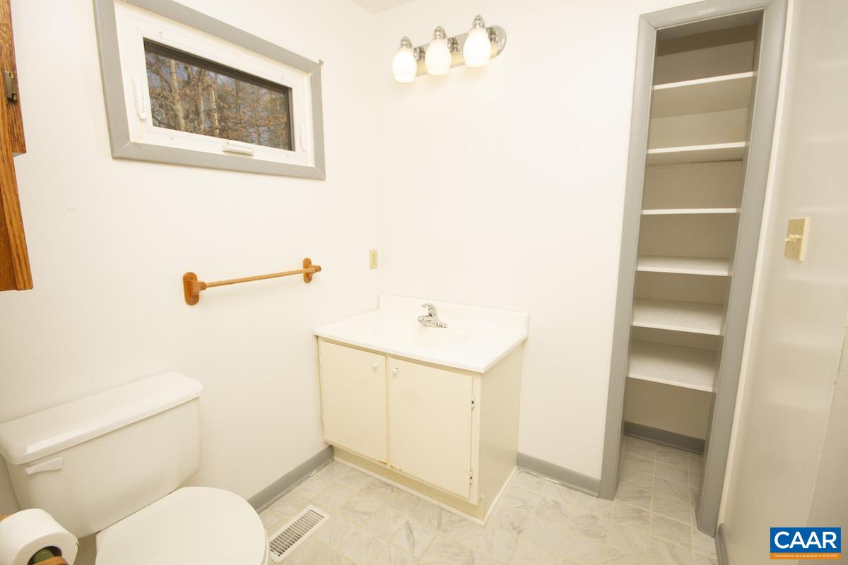 357 Logtrac Road Stanardsville, VA 22973 - Photo 18 of 36 a bathroom with a toilet sink and vanity
