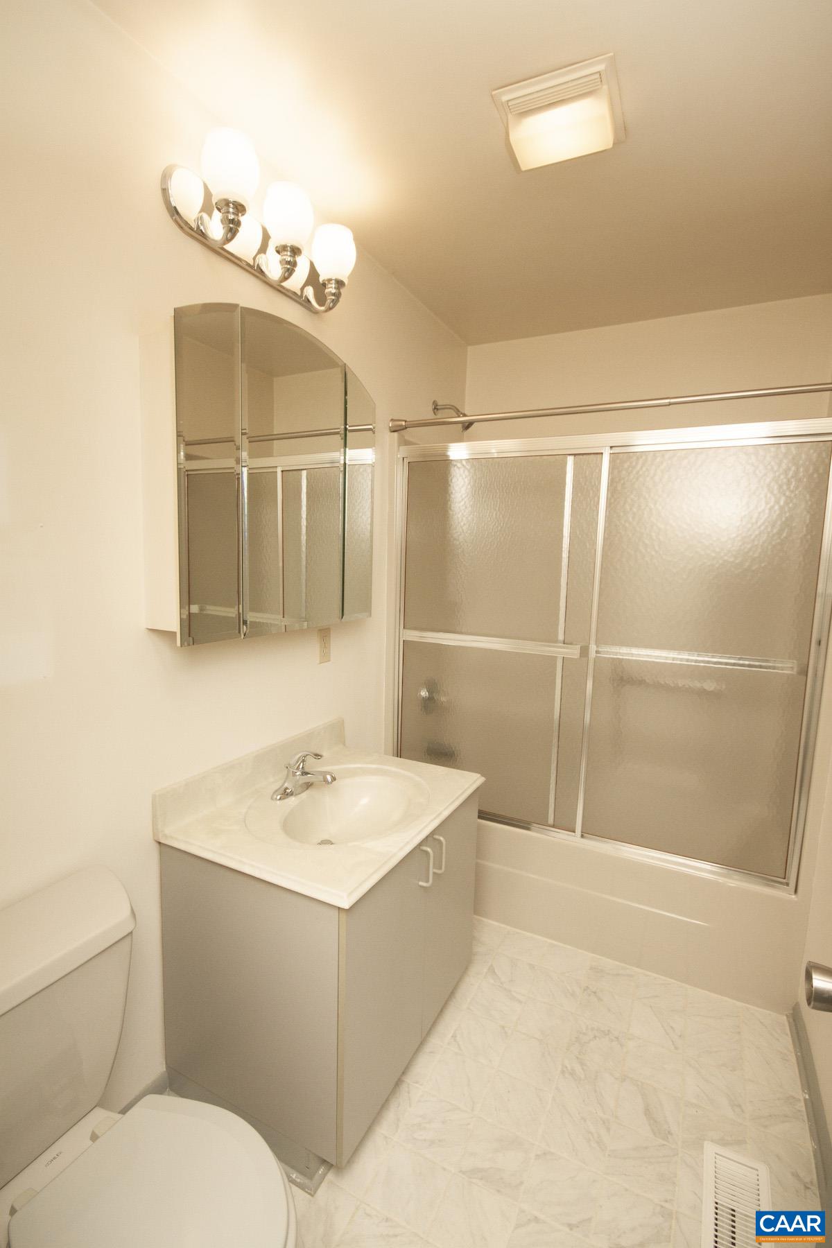 357 Logtrac Road Stanardsville, VA 22973 - Photo 20 of 36 a bathroom with a sink a toilet a mirror and shower