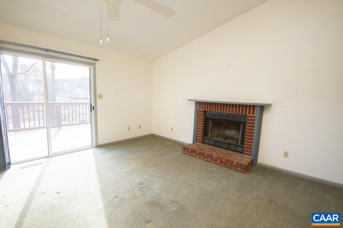 357 Logtrac Road Stanardsville, VA 22973 - Photo 7 of 36 an empty room with a fireplace and window