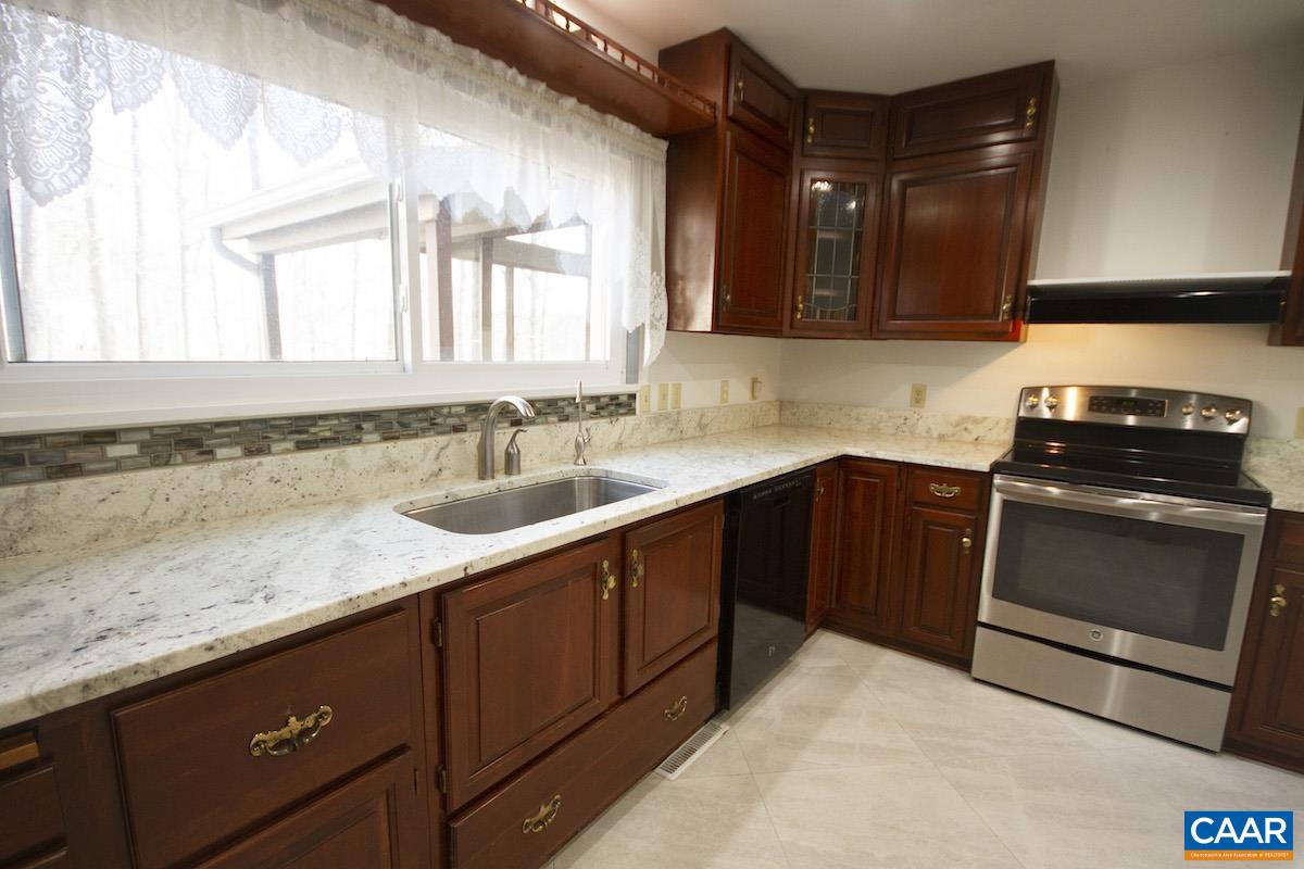 357 Logtrac Road Stanardsville, VA 22973 - Photo 9 of 36 a kitchen with granite countertop a sink and cabinets