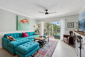 200 East Royal Palm Road, Unit 3030 Boca Raton, FL 33432 - Photo 11 of 30 a living room with couch floor to ceiling window and a flat screen tv