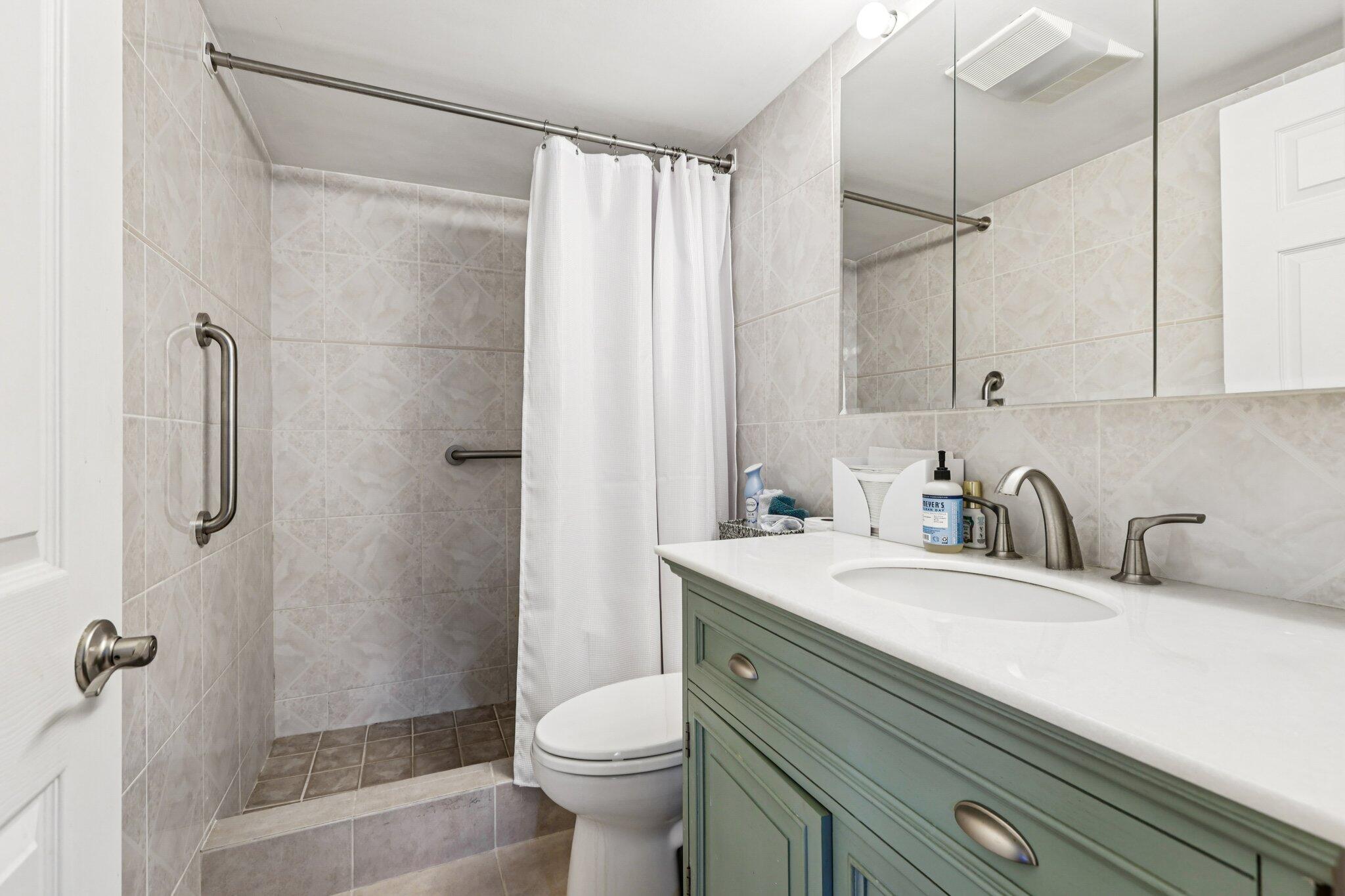 200 East Royal Palm Road, Unit 3030 Boca Raton, FL 33432 - Photo 17 of 30 a bathroom with a sink a toilet and shower