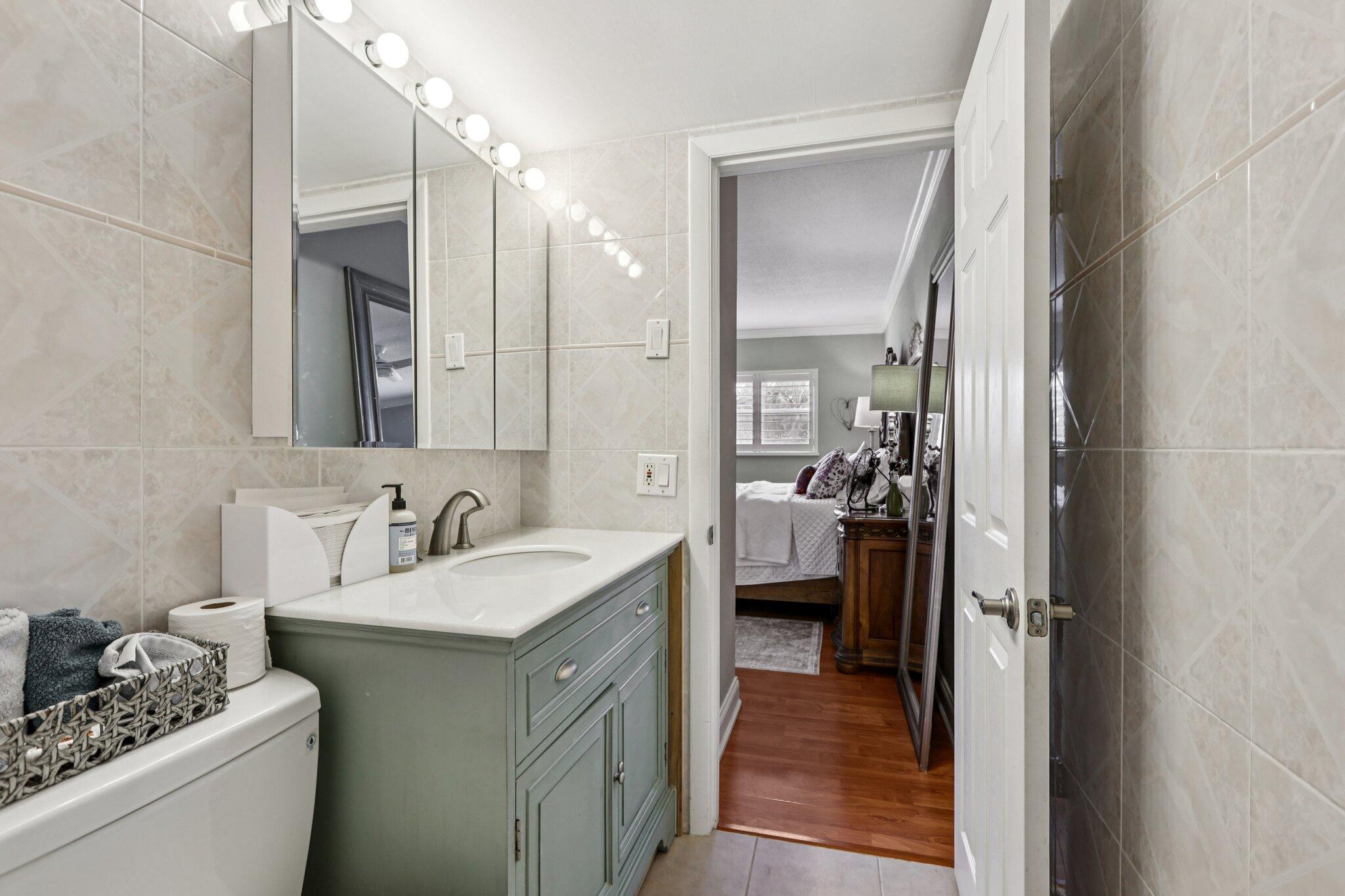 200 East Royal Palm Road, Unit 3030 Boca Raton, FL 33432 - Photo 18 of 30 a en suite bathroom with a sink a mirror and a shower