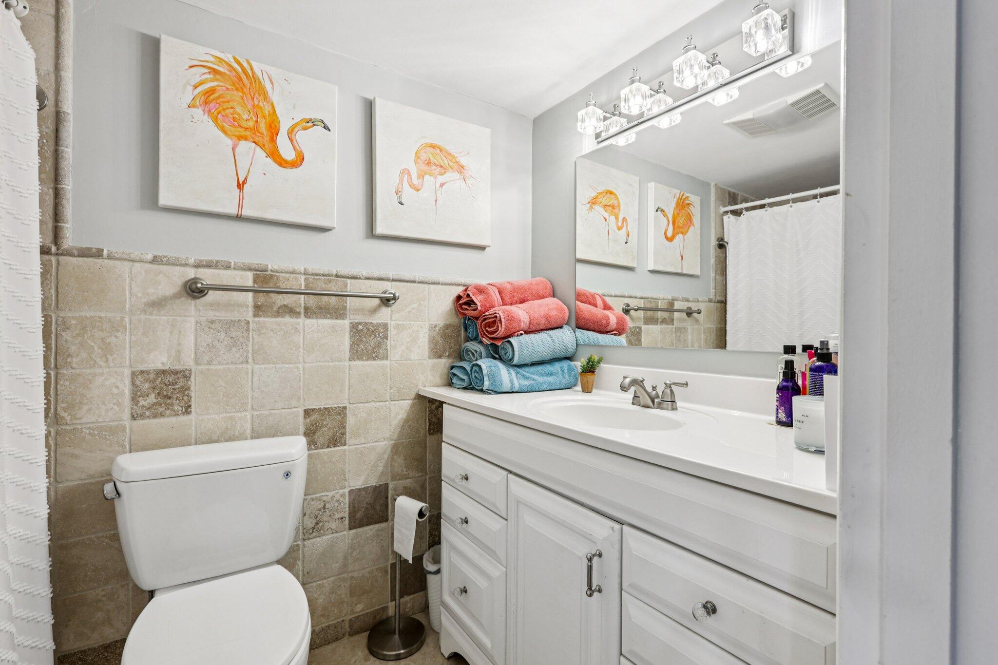200 East Royal Palm Road, Unit 3030 Boca Raton, FL 33432 - Photo 24 of 30 a bathroom with a sink mirror vanity and toilet