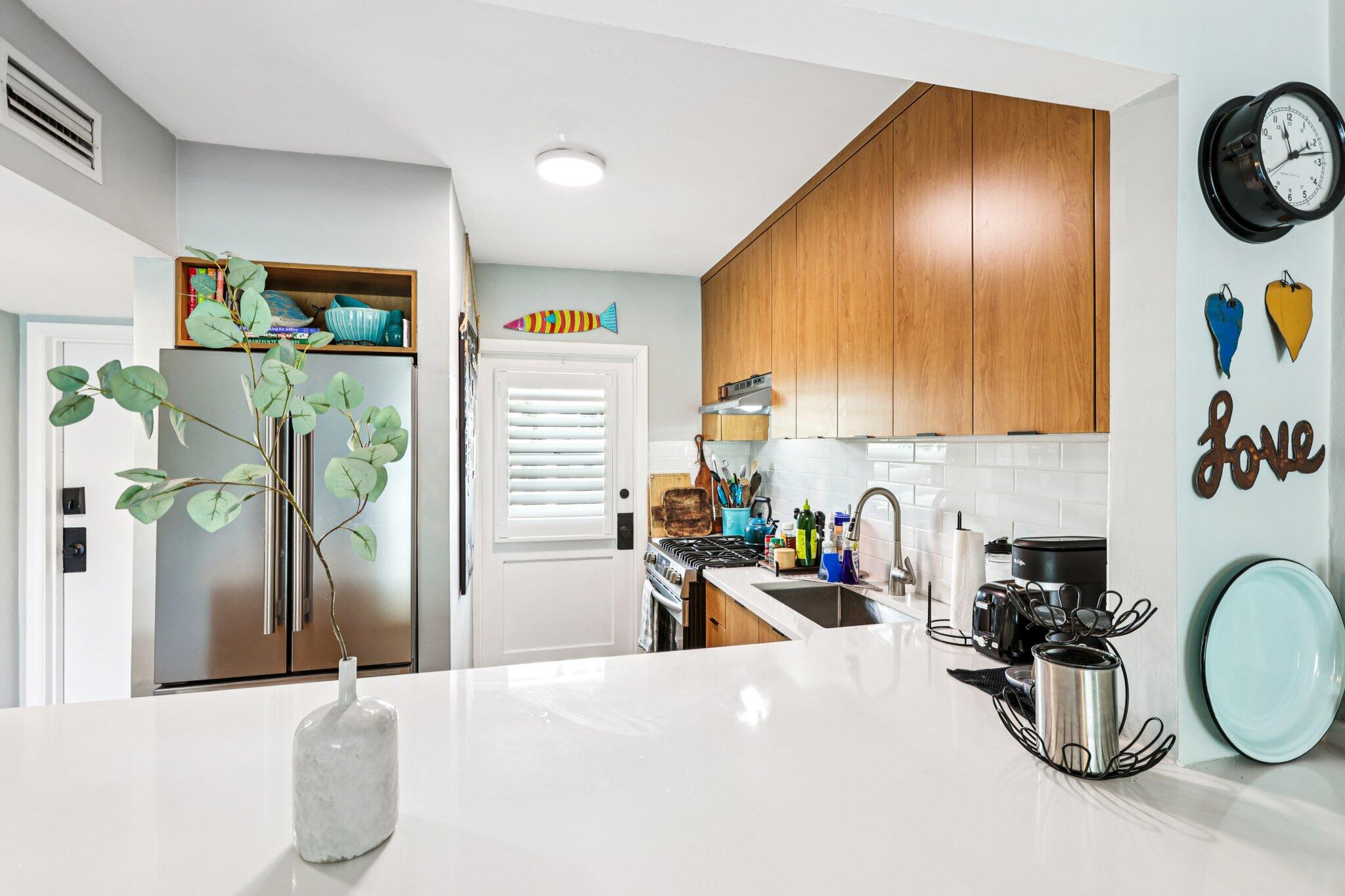 200 East Royal Palm Road, Unit 3030 Boca Raton, FL 33432 - Photo 4 of 30 a kitchen with stainless steel appliances kitchen island granite countertop a sink a stove and a refrigerator