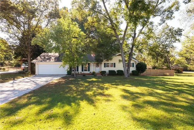 a view of a house with a large tree