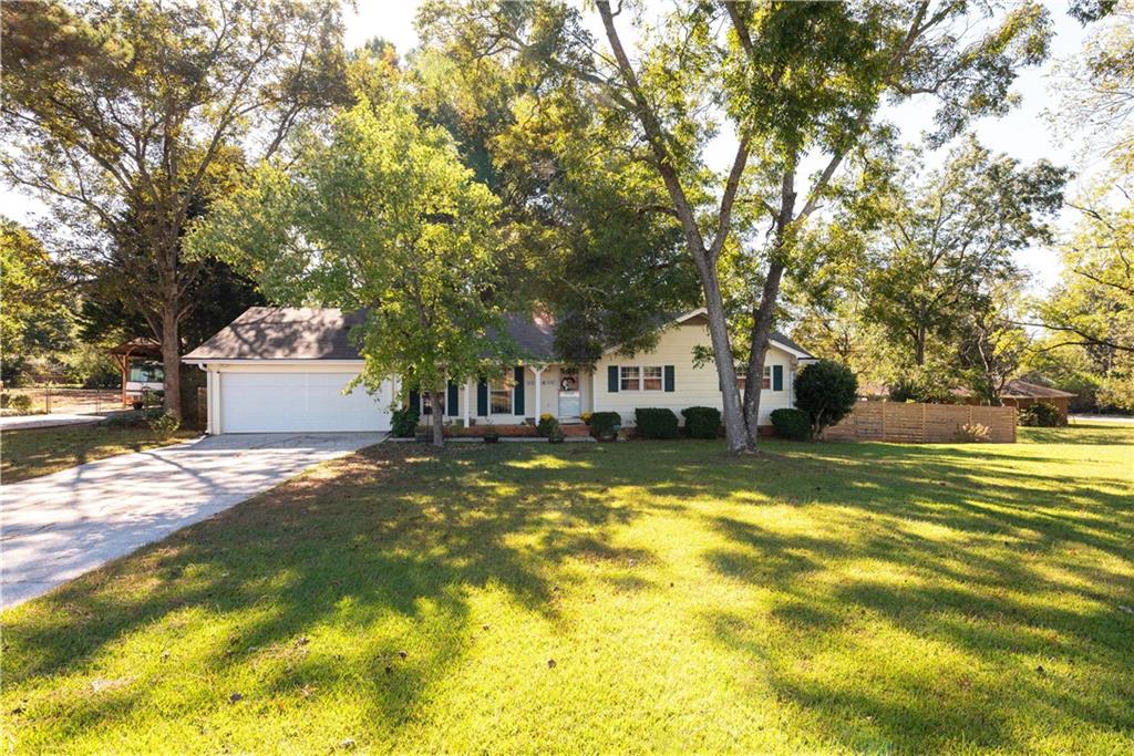 a view of a house with a large tree