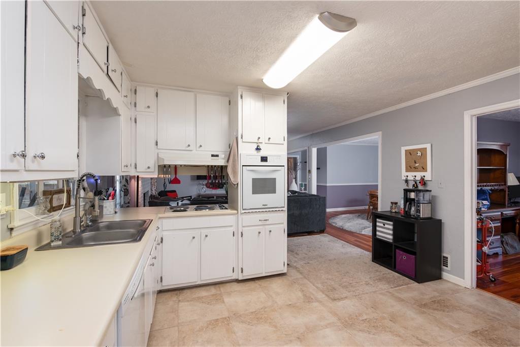 2598 Mountain View Road Snellville, GA 30078 - Photo 11 of 33 a kitchen with stainless steel appliances and white cabinets
