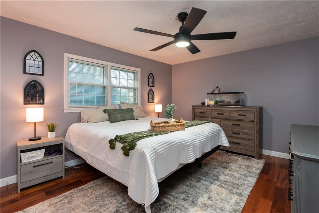 2598 Mountain View Road Snellville, GA 30078 - Photo 14 of 33 a bedroom with a bed and a chandelier