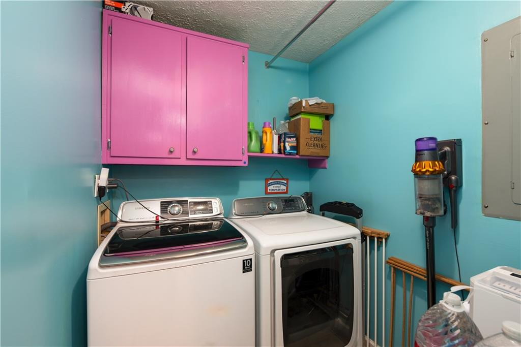 2598 Mountain View Road Snellville, GA 30078 - Photo 22 of 33 a utility room with dryer washer and a fridge
