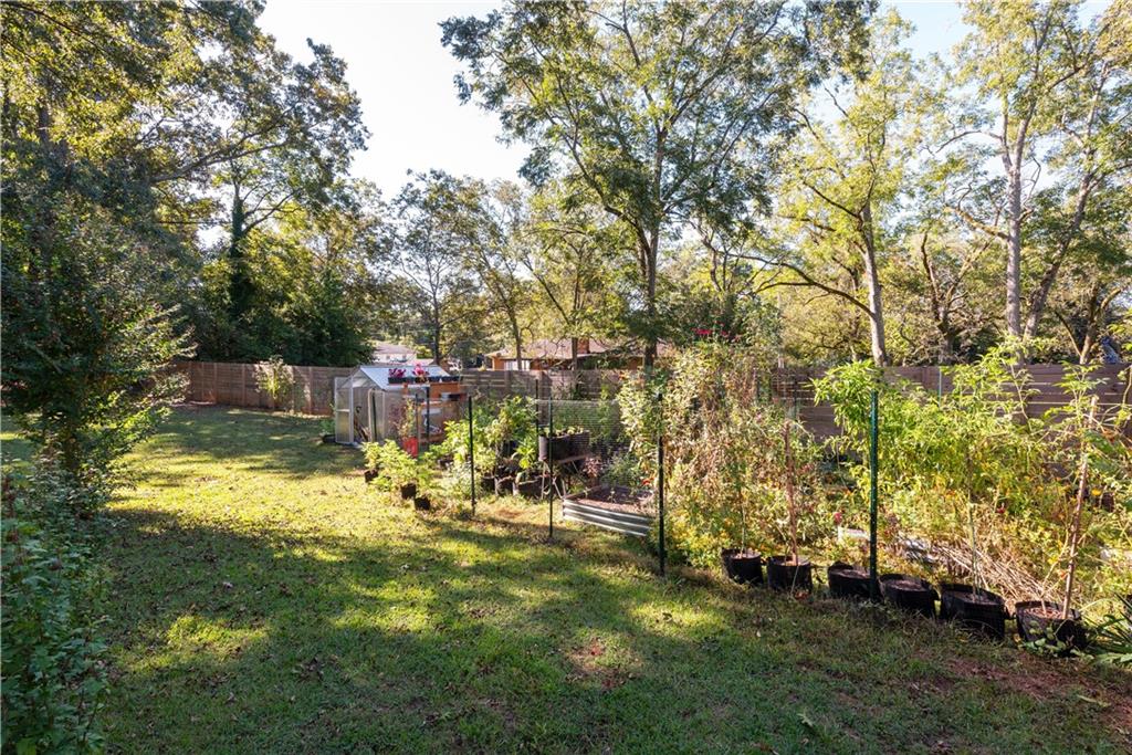 2598 Mountain View Road Snellville, GA 30078 - Photo 29 of 33 a view of yard with swimming pool and trees