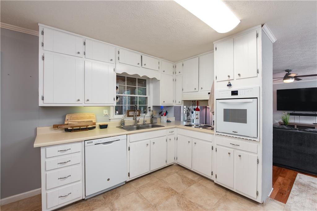 2598 Mountain View Road Snellville, GA 30078 - Photo 10 of 33 a kitchen with cabinets appliances a sink and a counter space
