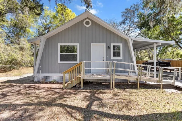 a view of a house with a wooden fence