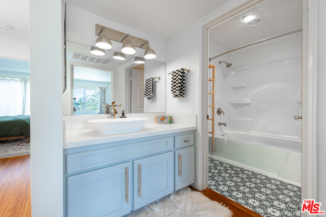 1001 Figueroa Terrace, Unit 305 Los Angeles, CA 90012 - Photo 12 of 18 a bathroom with a shower a sink and a mirror