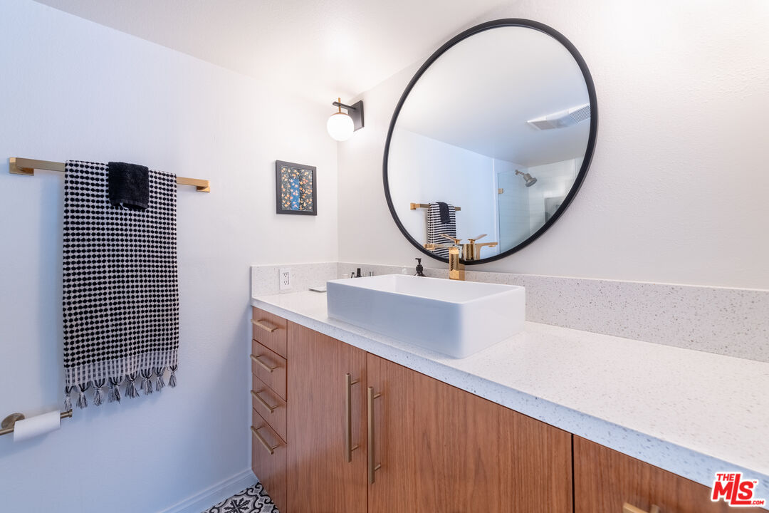 1001 Figueroa Terrace, Unit 305 Los Angeles, CA 90012 - Photo 14 of 18 a bathroom with a sink and a mirror