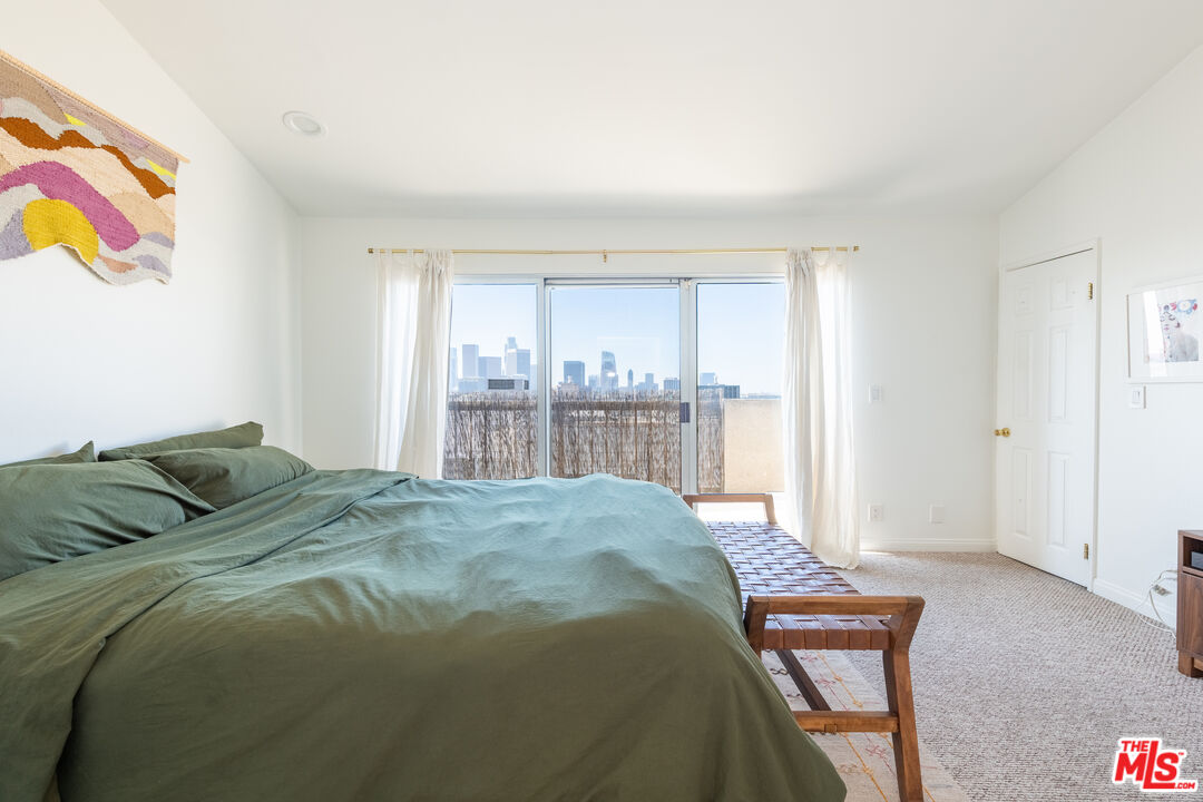 1001 Figueroa Terrace, Unit 305 Los Angeles, CA 90012 - Photo 10 of 18 a bed sitting in a bedroom next to a window