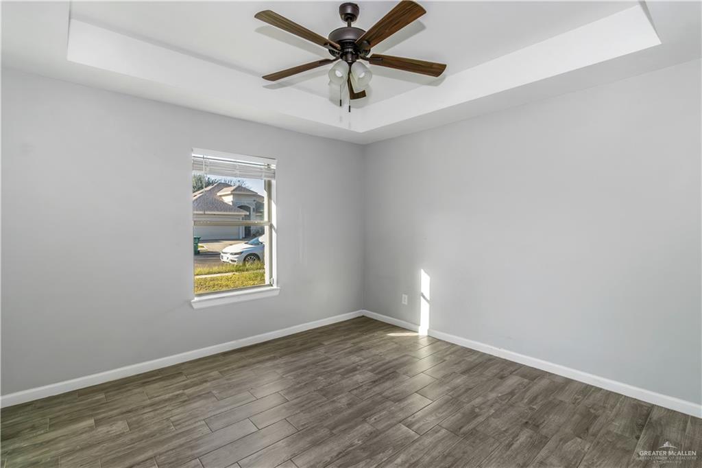 4117 South Las Nubes Street Pharr, TX 78577 - Photo 12 of 18 an empty room with a window and a ceiling fan