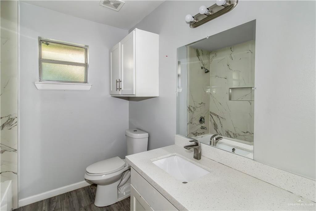 4117 South Las Nubes Street Pharr, TX 78577 - Photo 13 of 18 a bathroom with a sink a toilet and shower