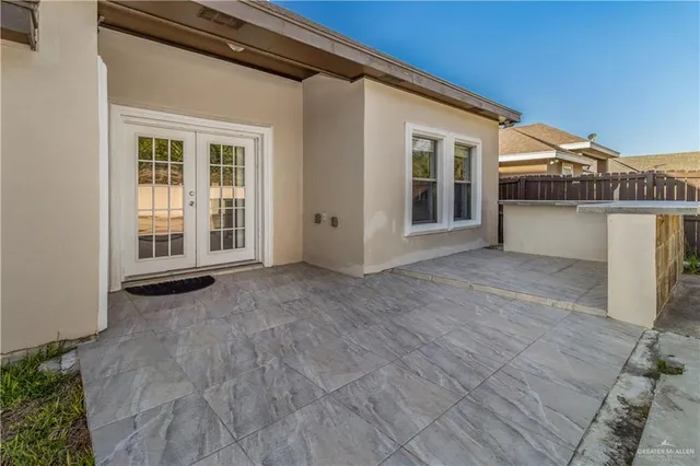 a view of backyard with large window and wooden floor