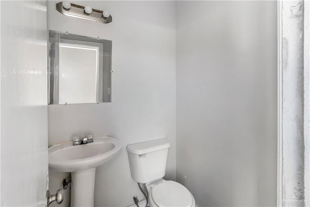 4117 South Las Nubes Street Pharr, TX 78577 - Photo 17 of 18 a bathroom with a toilet sink and mirror