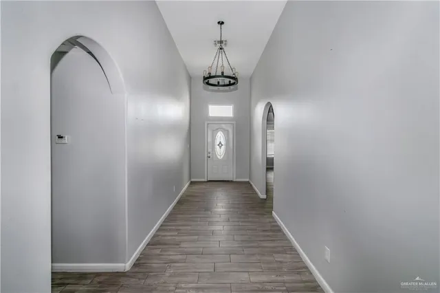 a view of a hallway with wooden floor