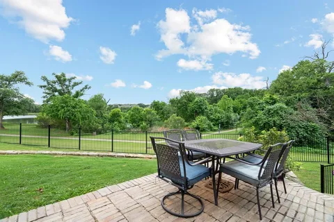 a view of a backyard with table and chairs and a yard