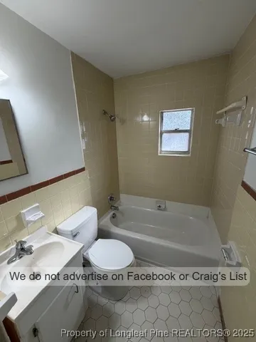 a bathroom with a sink a toilet and bathtub