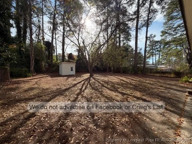 a view of a backyard with large trees
