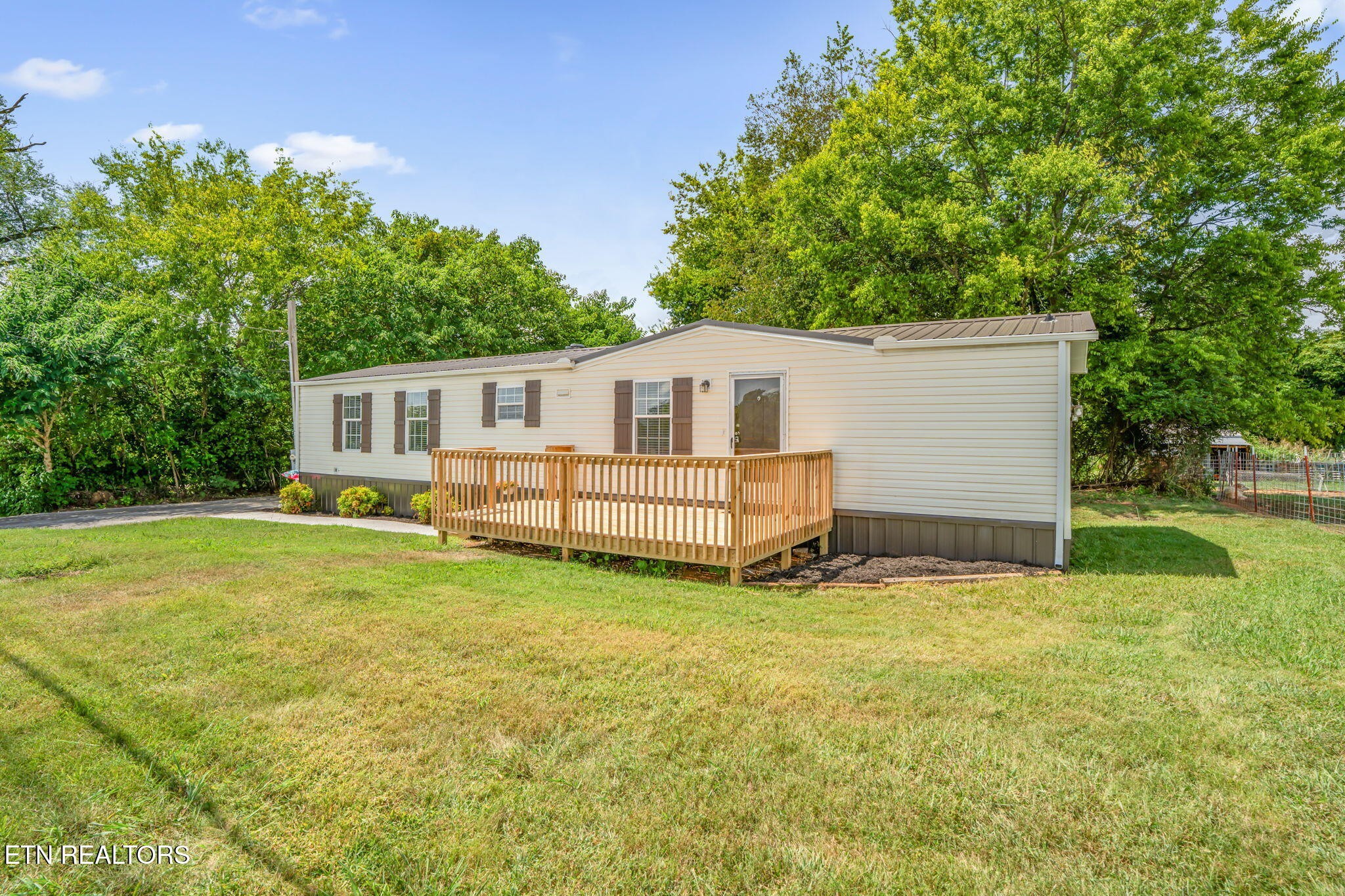 a view of a house with a backyard
