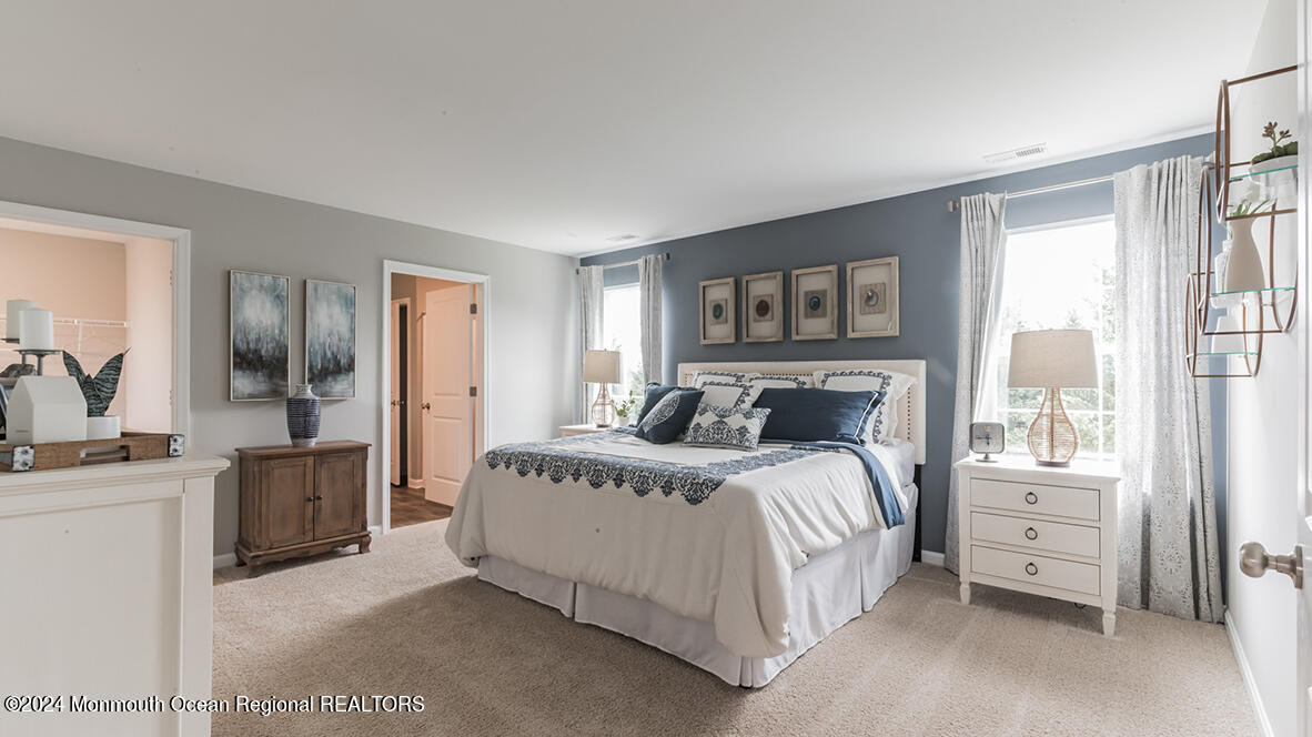 107 West 6th Street Howell, NJ 07731 - Photo 21 of 25 a spacious bedroom with a large bed and a large window