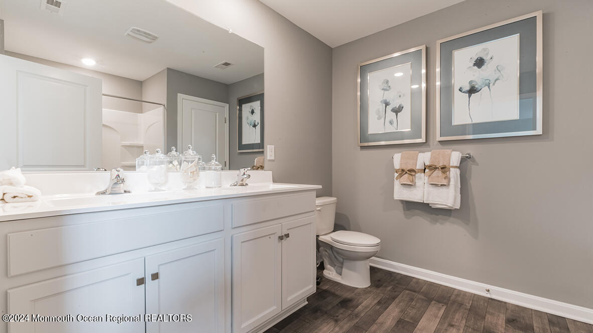 107 West 6th Street Howell, NJ 07731 - Photo 23 of 25 a bathroom with a toilet sink and mirror