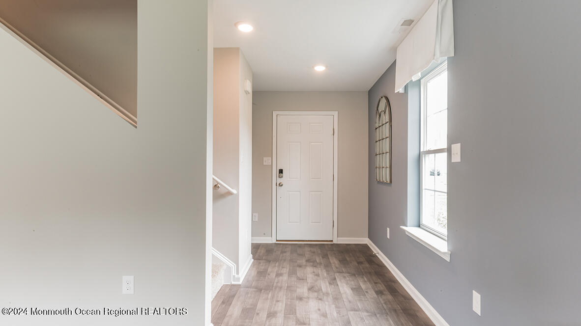 107 West 6th Street Howell, NJ 07731 - Photo 5 of 25 a view of hallway with window and wooden floor