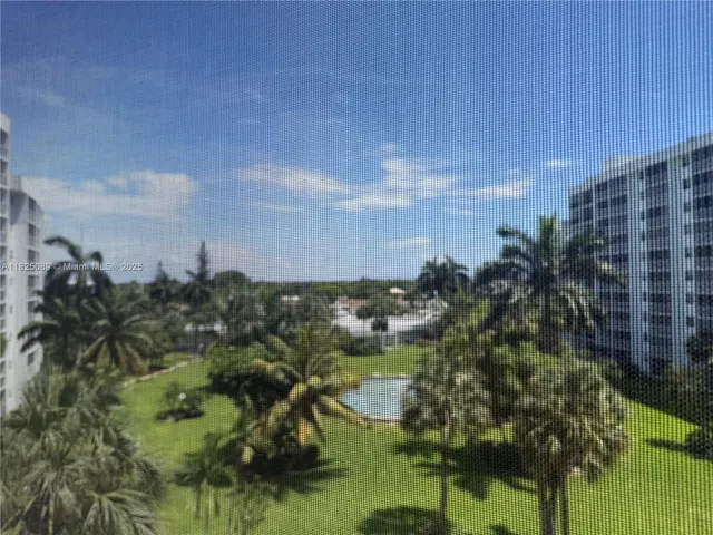 a room with a refrigerator and mirror