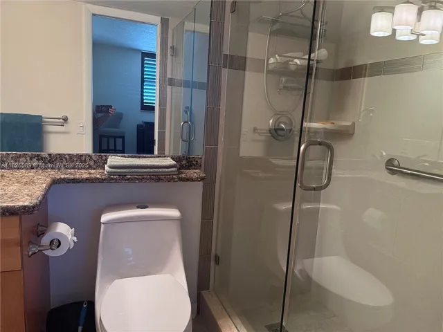 a bathroom with a toilet and a shower