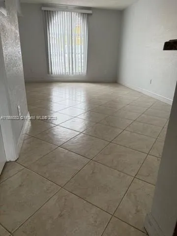 a view of an empty room and a window