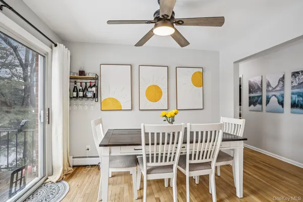 a view of a dining room with furniture and wooden floor