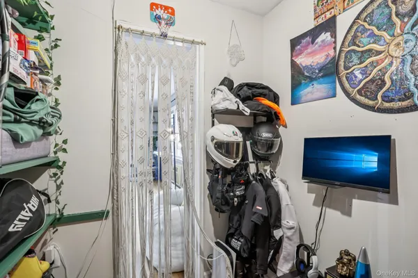 a bedroom with a bed wooden floor and window