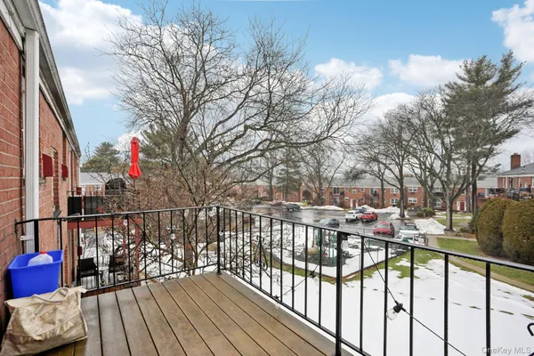 a view of a brick house with a large trees